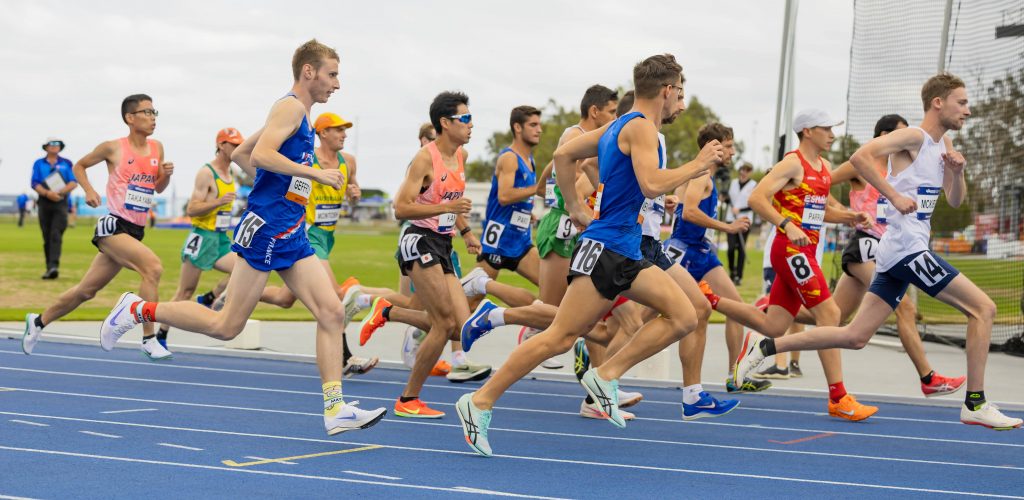 A group of athletes racing on an athletics track